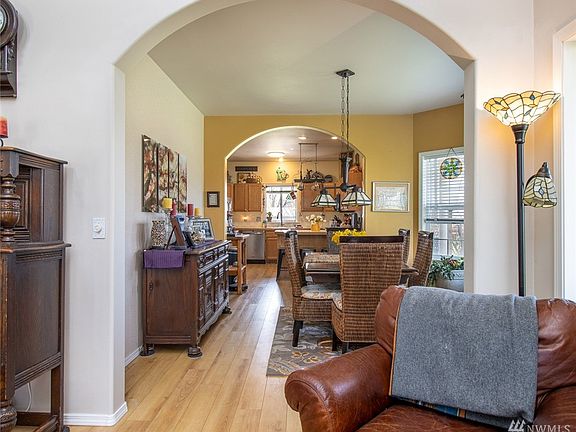 Peering from the living space to the dining & kitchen areas. Unique archways lead to a nice architectural element.