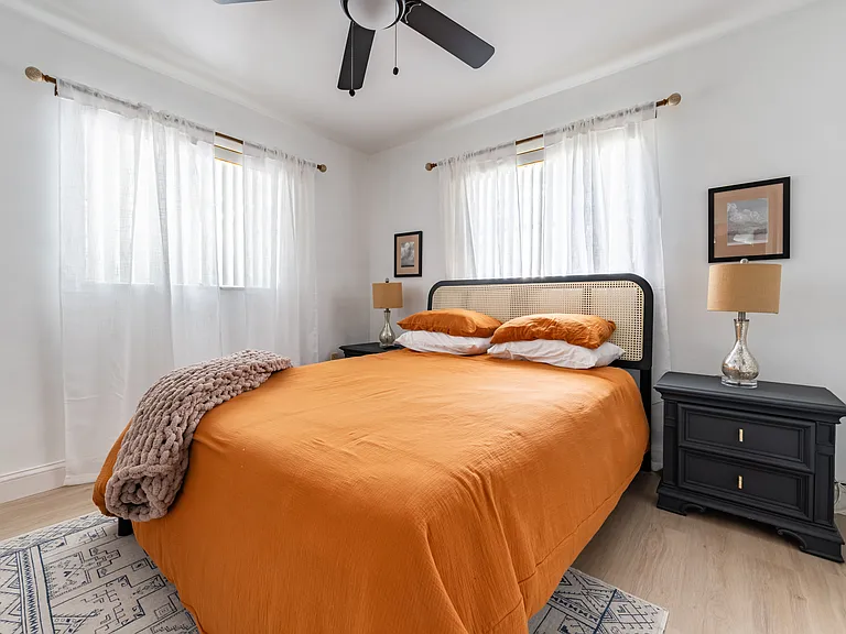 The second bedroom features a queen-sized nectar mattress, nightstands, and a smart TV.