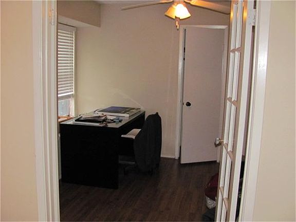 Study/3rd bedroom with french doors and laminate wood flooring