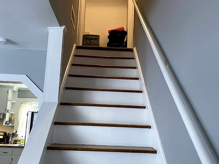 Open staircase leads up to 2 bedrooms and additional 1/2 bath.