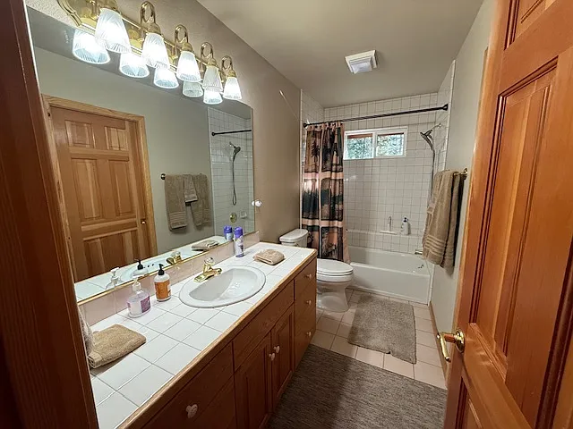 Upstairs bath with tub shower and lots of drawers