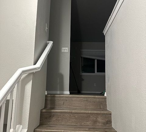 Stairs heading up from the front door. Stairs heading downstairs is to the left.