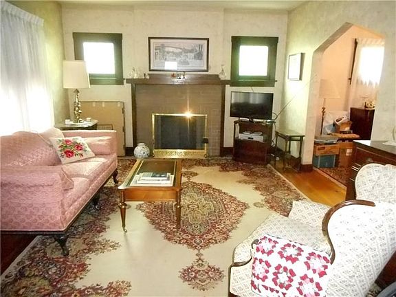 Living Room: Nostalgic stained glass windows encompass the gas fireplace with natural wood mantel.