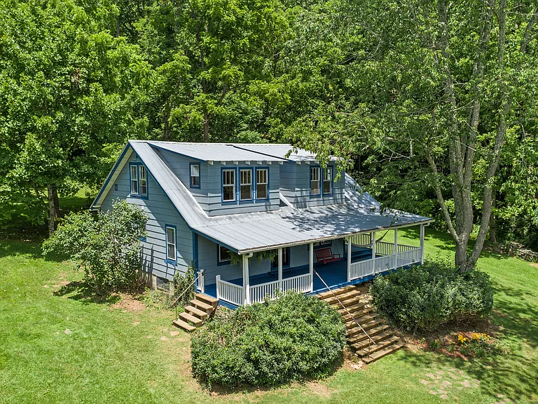 The huge wrap around porch is the center of the home. Enjoy morning coffee from the porch while watching the mist burn off the mountains.