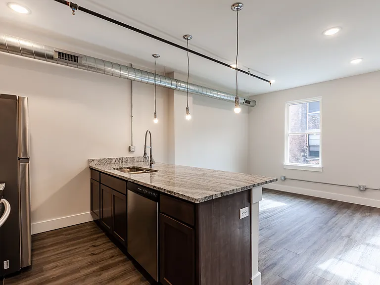 Spacious kitchen with solid wood cabinets, granite counters and stainless appliances.