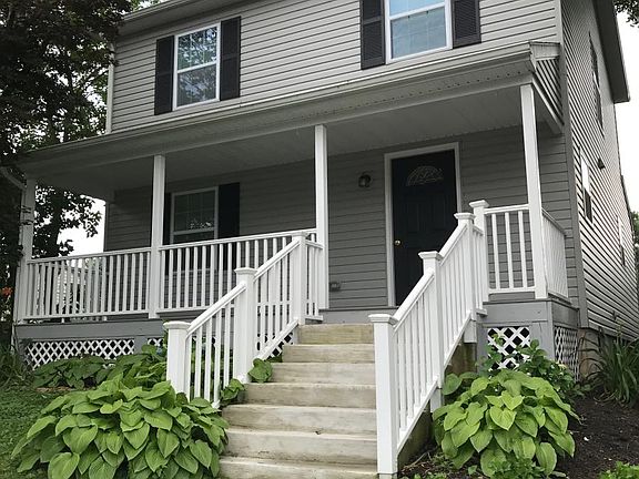 Front view. Driveway on the right side.