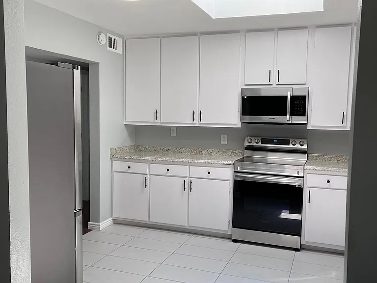 brand new kitchen appliances and tile floor! very bright room with natural light from skylight!