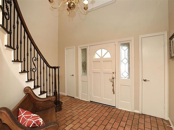 Crown molding, brick flooring lovely entry