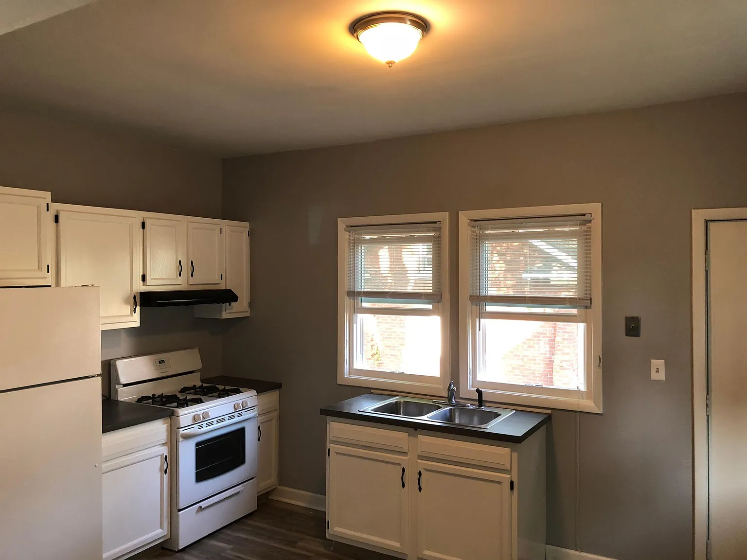 Newly remodeled kitchen including new windows, floor, appliaces, window treatments and more.