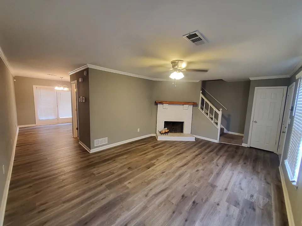 Living room view toward entrance (right) and Dining/Kitchen (left)