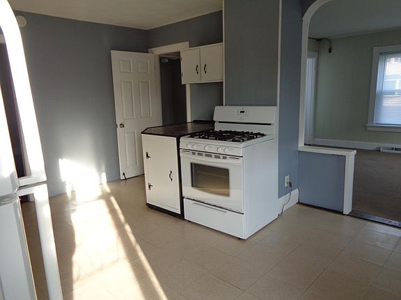 More cabinets and huge counter top next to the gas range.