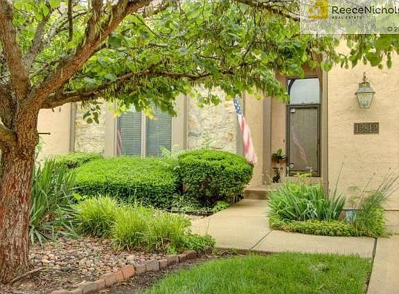 Front door entry with large transom window above door allowing n
