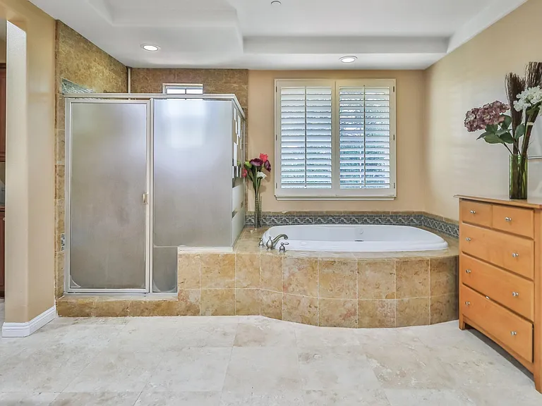 Main bathroom with separate tub and shower. The tub is a spa tub.
