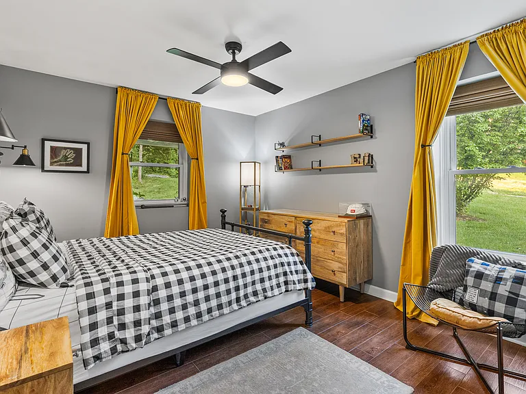 Bedroom #2 with a Queen bed, room-darkening shades, ceiling fan, and a dresser.