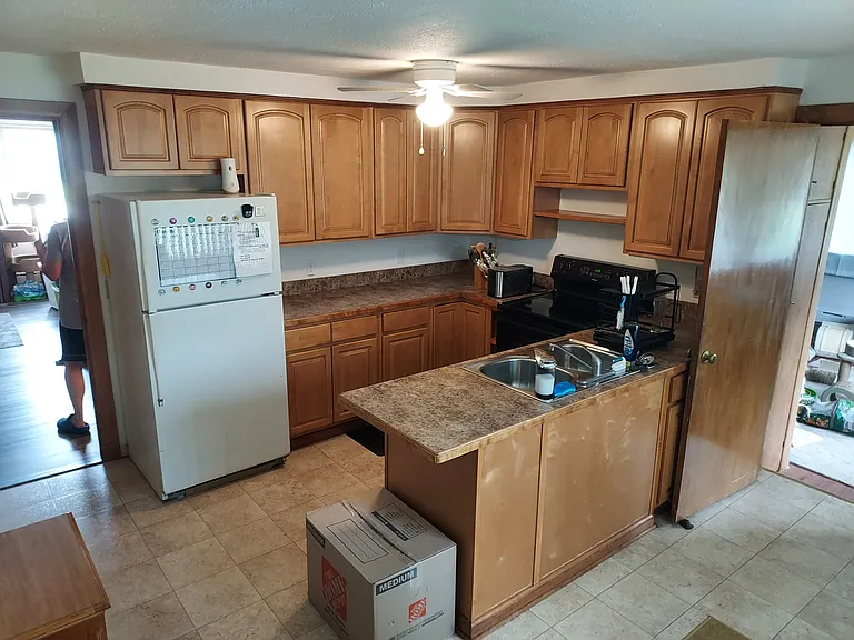 Kitchen with the BONUS large office off the back. Also, large windows throughout the office and kitchen bring in TONS of natural light and look out onto the private backyard.