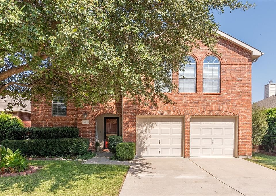 Beautiful Curb Appeal showing extensive landscaping! Also showing the nice glass storm door!