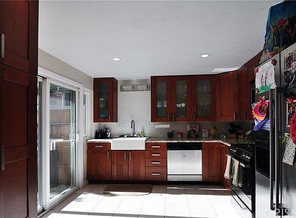 Remodeled Kitchen with farm sink, granite counters and stainless steel appliances.