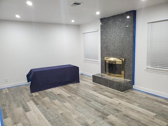 Spacious Living Room with fireplace. Living facing the backyard.