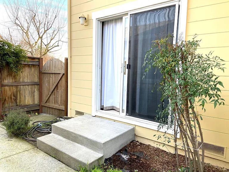 Slider to Kitchen from Fenced in Backyard.