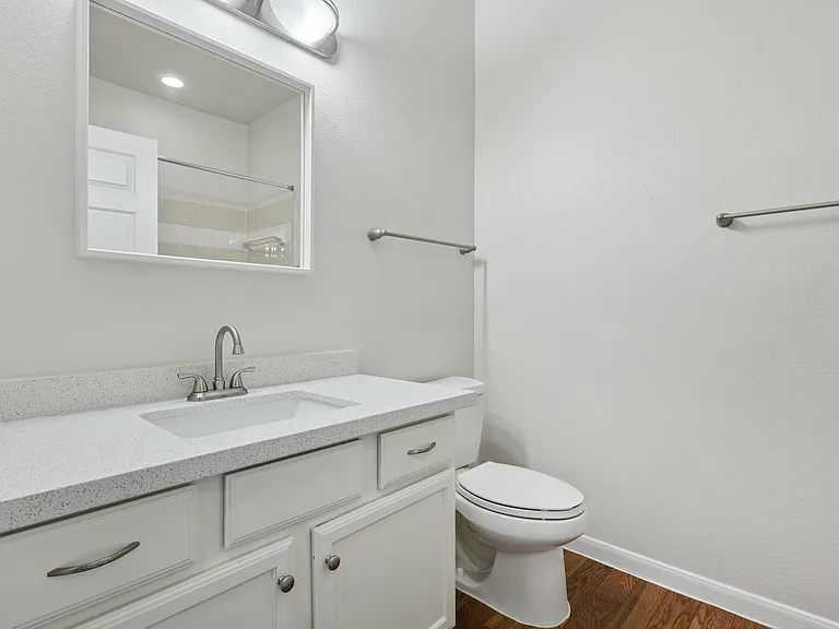 Modern bathroom with a sleek white quartz vanity, elegant lighting, and polished fixtures, offering a luxurious and clean ambiance. Modern bathroom with a sleek white quartz vanity, elegant lighting, and polished fixtures, offering a luxurious and clean a
