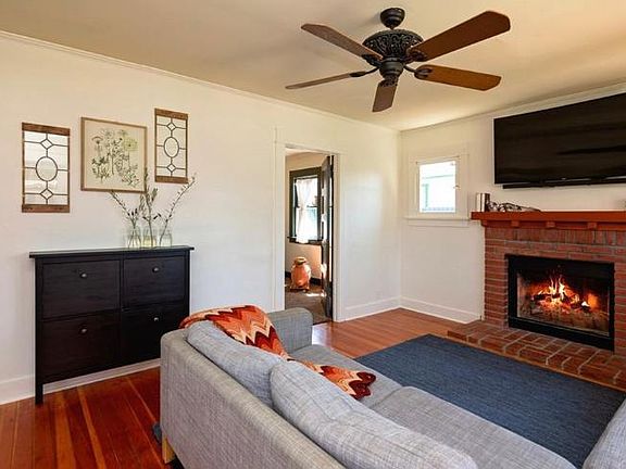 Living room with wood burning fireplace
