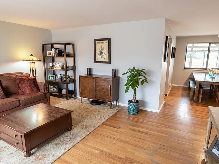 View from the front door, showing the relationship between the living room, dining room, kitchen entry, and the sun room.