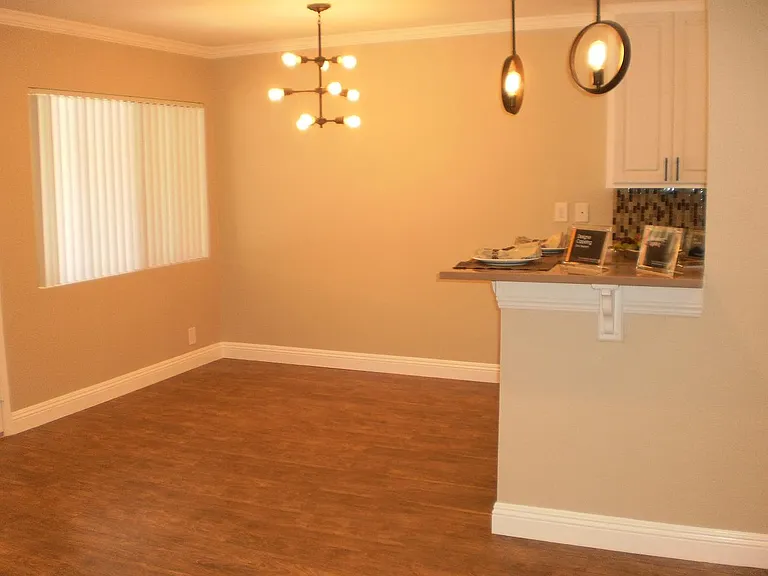 Spacious dining area that fits a 6 chair table with hardwood floor