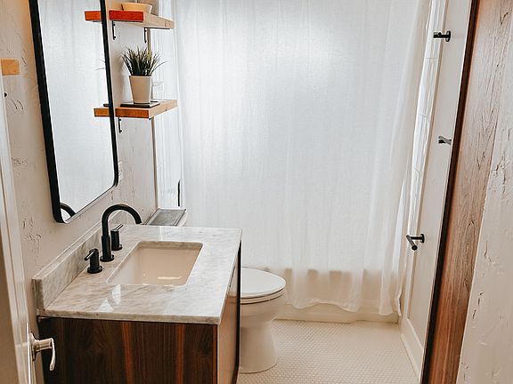 Upstairs bathroom with mid-century modern cabinets and updated, elevated fixtures.