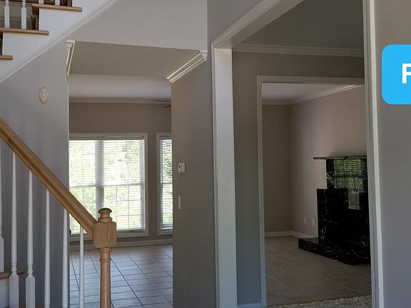 Inside front door looking into the family room and at freshly painted walls throughout the house.