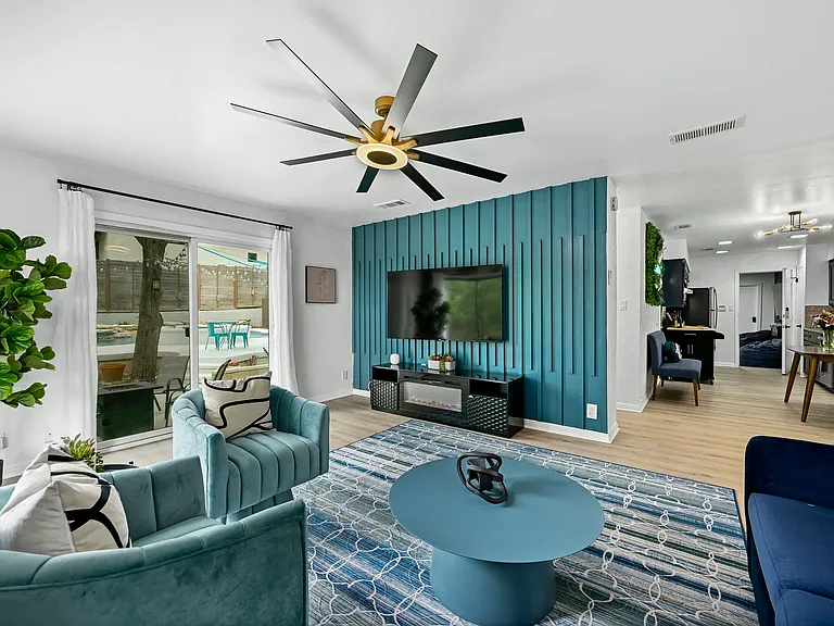 Unit B Living Room with custom curated furniture and wall furnishings all with a spectacular view of the backyard oasis!