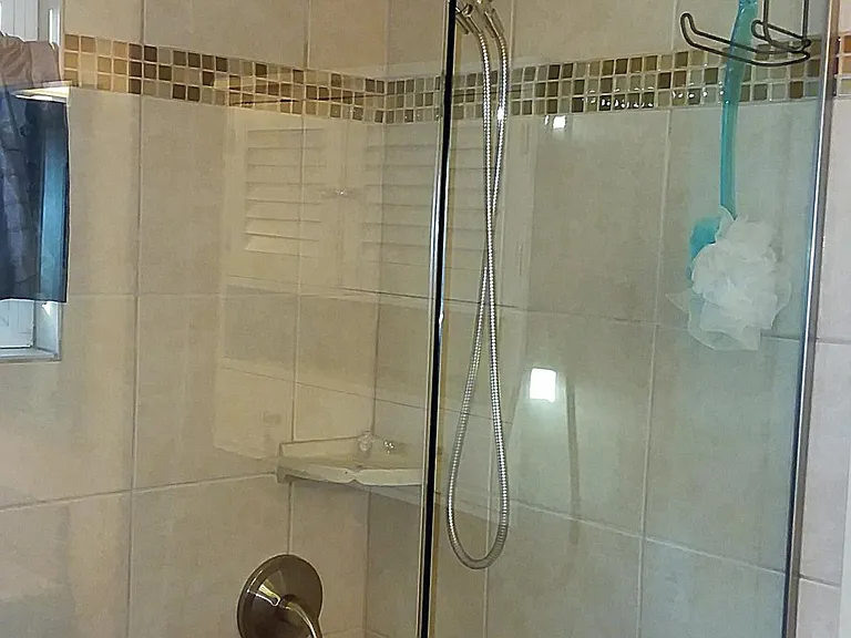 New master shower with glass and decorative tile
