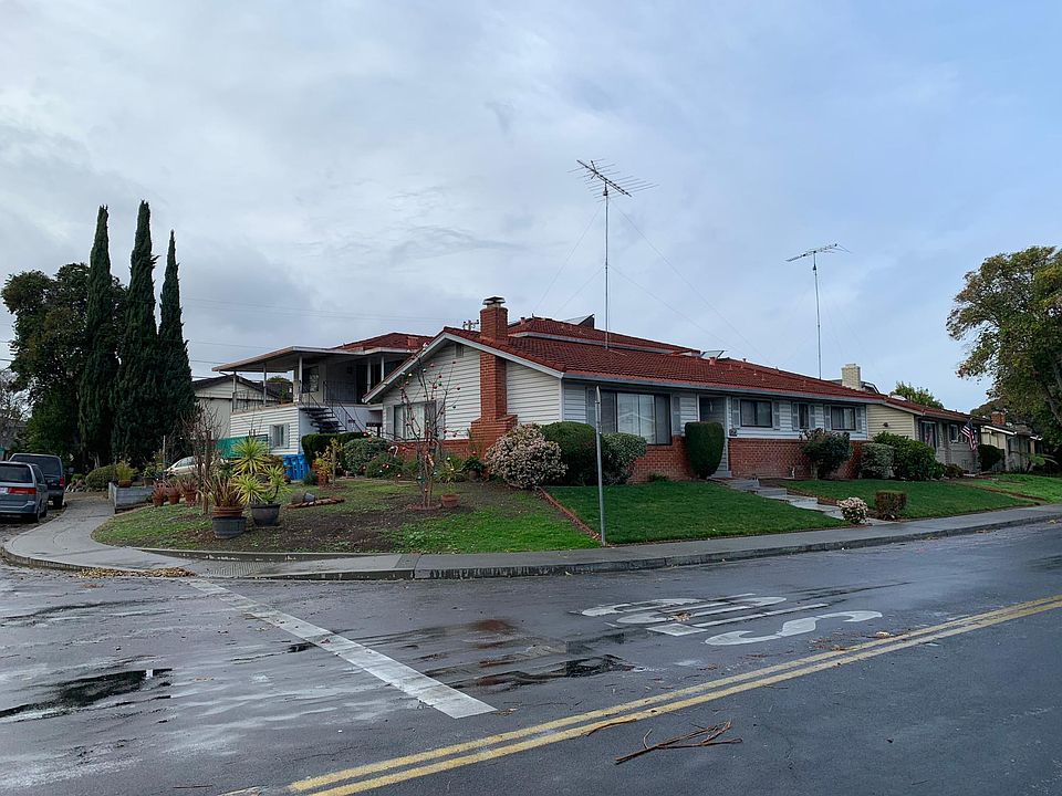 Street view of apartment complex. Upper unit is on the left side with the covered patio.