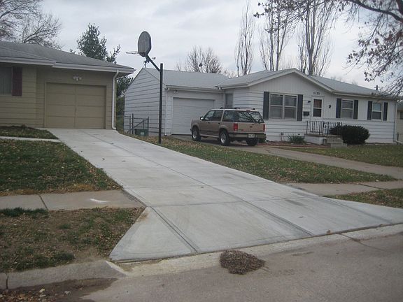 Newly poured driveway.  Shaved driveway.  Bball hoop.  