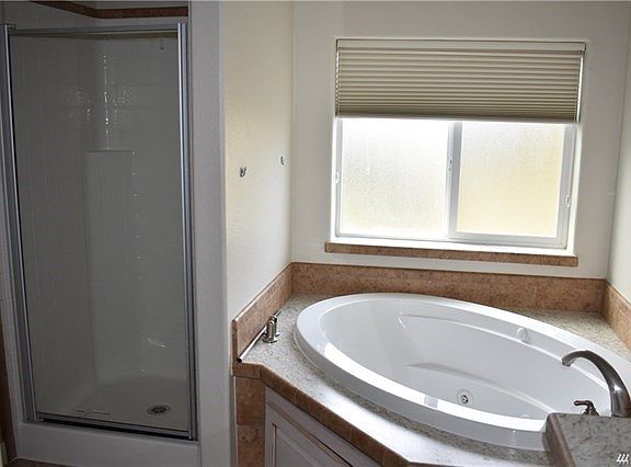 Master bath showing the jetted tub and walk in shower. Shower faces the toilet.