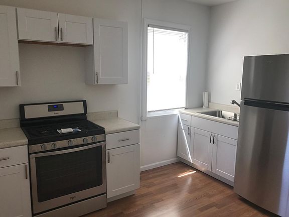 Kitchen with New Stainless Steel Appliances & cabinets & counters, sink, and faucet