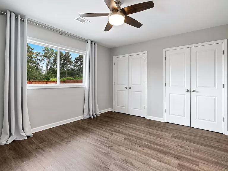Spacious primary bedroom with two generous closets.