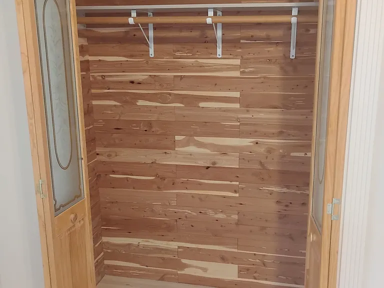 Cedar-lined closet. Inside the closet is a wall safe.