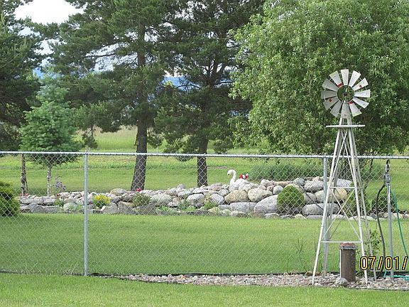 Shows fence & waterfall/pond