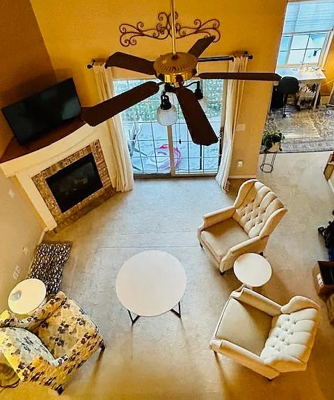 Living Space with tall 25 ft ceiling and gas fireplace