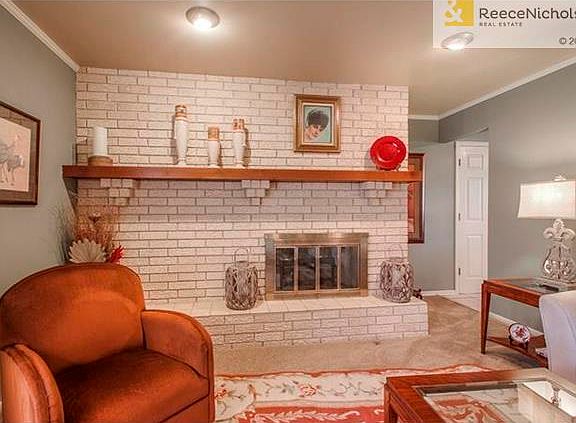 Lovely details throughout include this gas log fireplace and ceiling moldings
