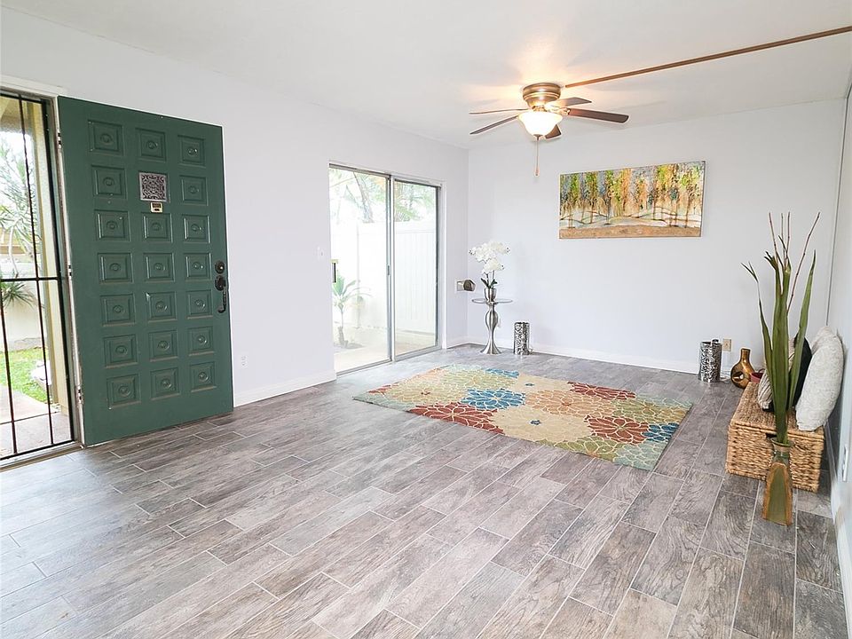 Enjoy the new ceramic tile and ceiling fan in this bright and spacious living room