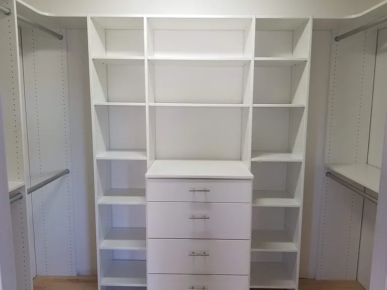 Primary bedroom's custom closet w/ extra deep drawers