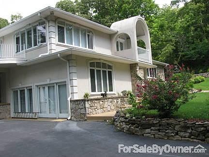 Side view from driveway
						:
						Master spacious bedroom on end of house with a private balcony