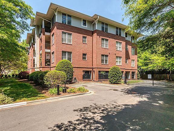 Side of building, gated parking entrance