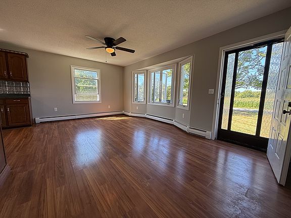 Enter into the living room with bay windows and hardwood floors.