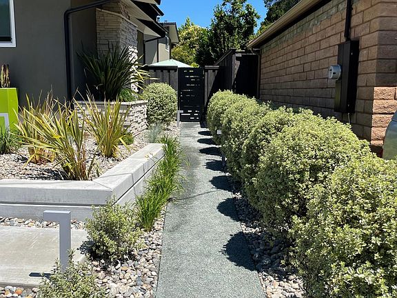 Professional landscaping captures native plants and mix of modern materials to capture your heart every time you come home.