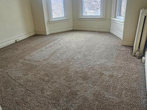 Main floor carpeted bedroom #2 w/ bay windows