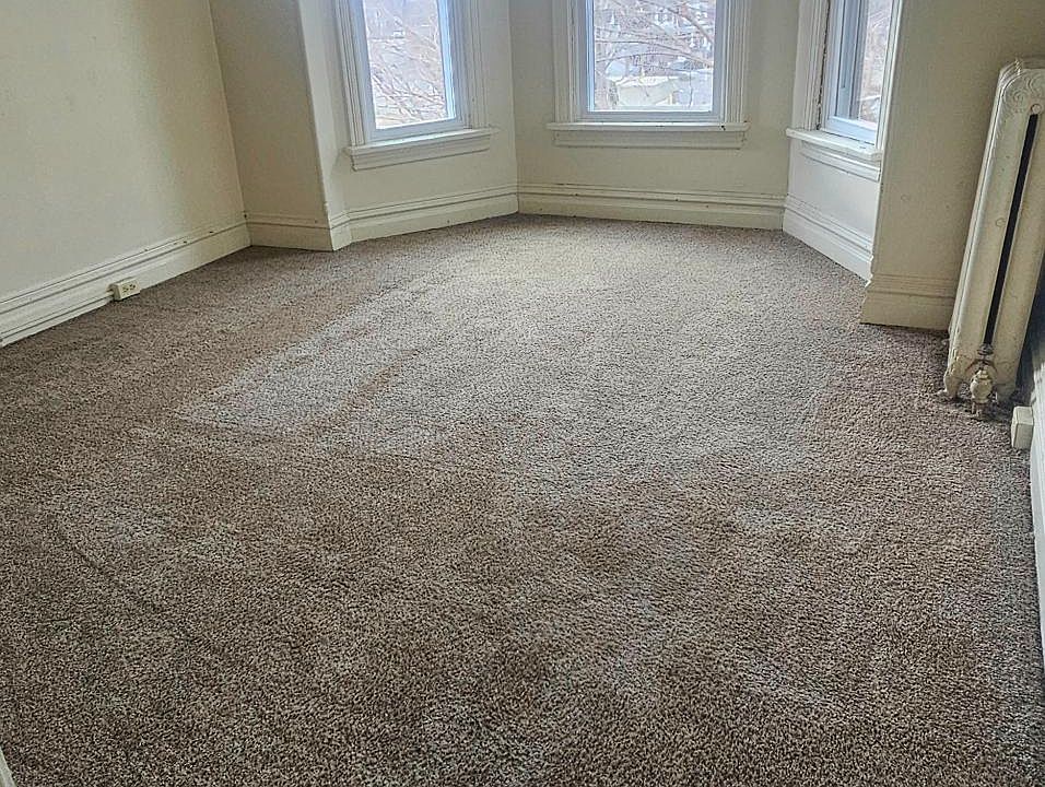 Main floor carpeted bedroom #2 w/ bay windows
