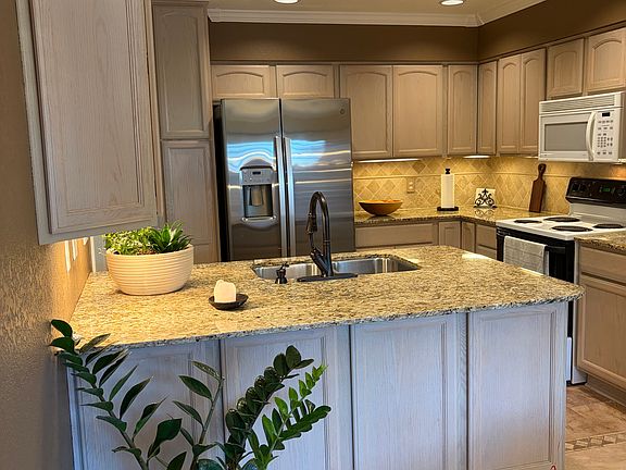 Kitchen with under-counter cabinets for extra storage in dining area