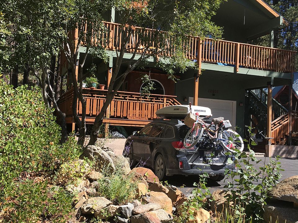 1. 12098 Sierra Dr E. front of house with subaru and bike